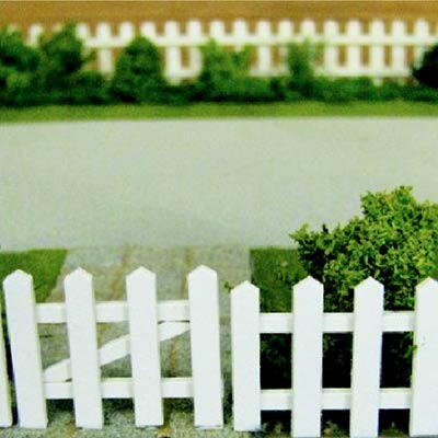 A model garden enclosed by a white card picket fence