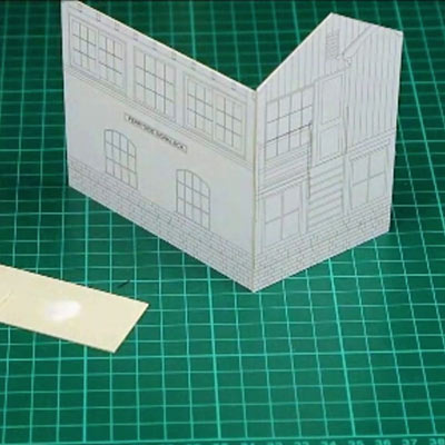 Metal rules, a scalpel and two craft knives on a cutting mat