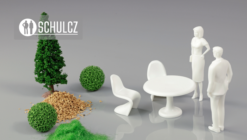 Schulcz white scale figures, furniture and model trees on a grey base
